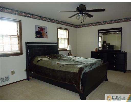 6 Purdue Road Edison, NJ 08820 - Photo 6 of 15 a bedroom with a bed and a chandelier