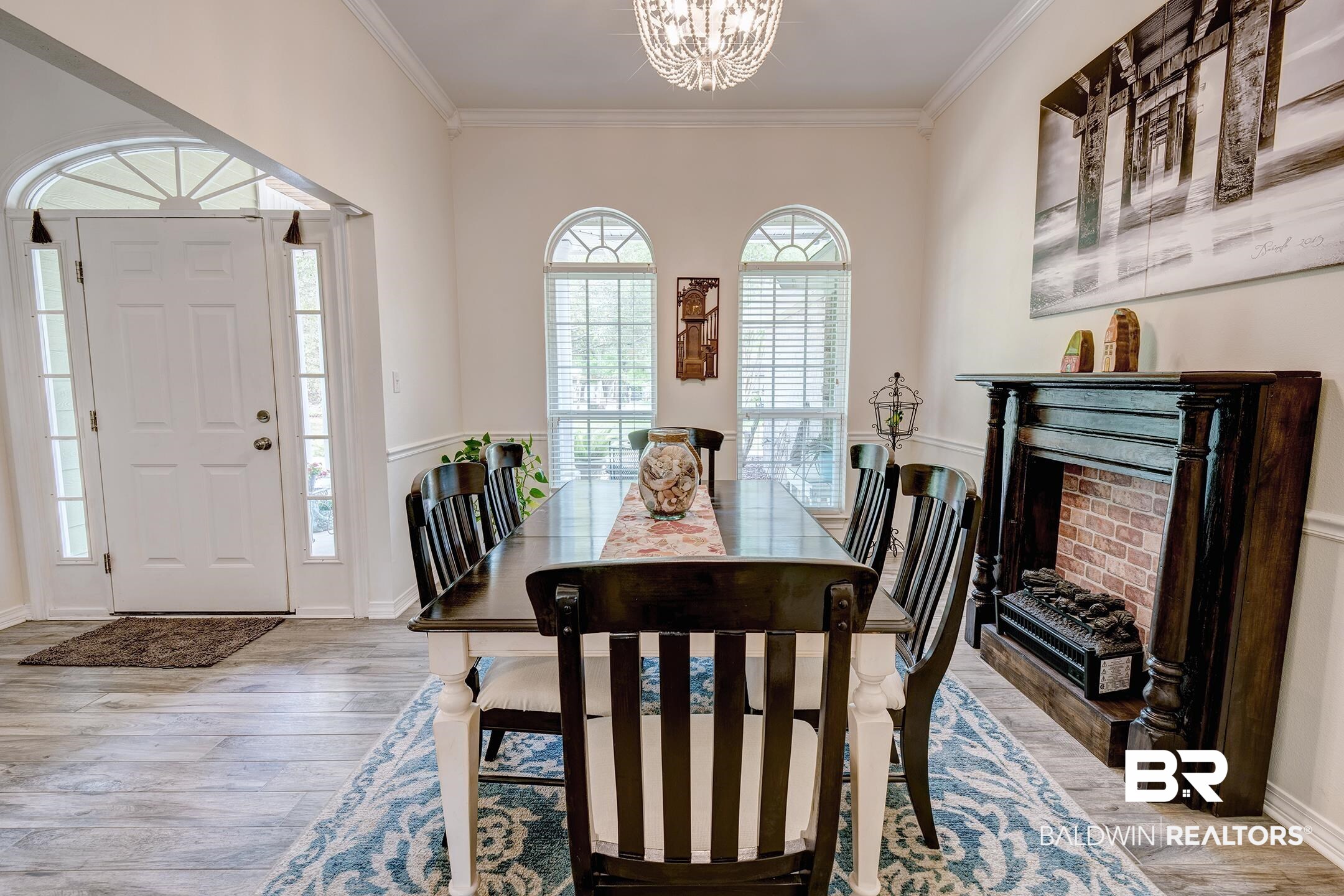 10093 Willis Road Foley, AL 36535 - Photo 5 of 33 Dining room with ornamental molding, a fireplace, light wood finished floors, and a chandelier