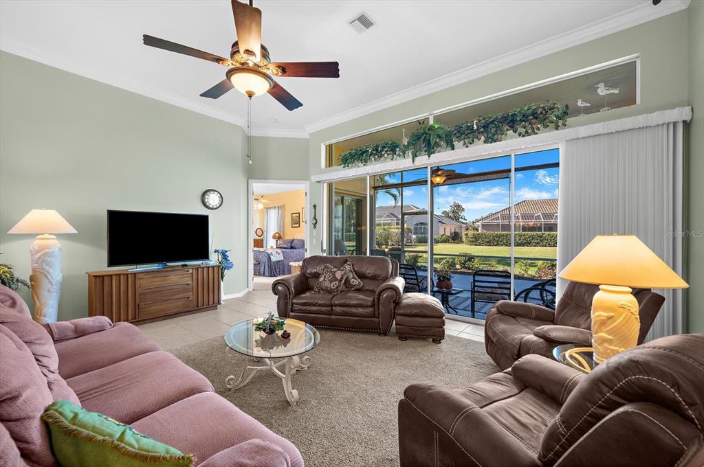 615 May Apple Way Venice, FL 34293 - Photo 21 of 94 a living room with furniture a lamp and a flat screen tv
