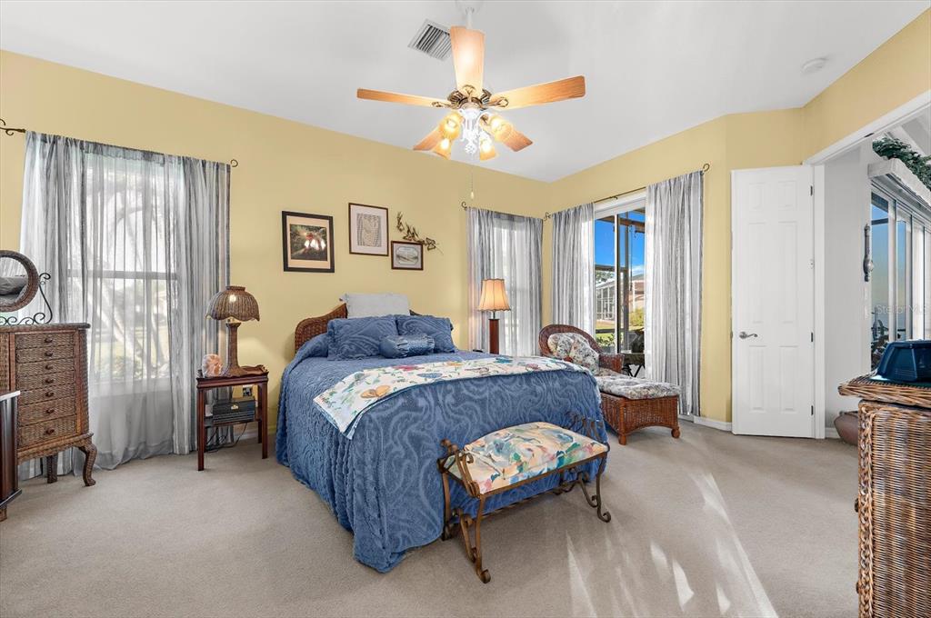 615 May Apple Way Venice, FL 34293 - Photo 32 of 94 a bed room with a bed and a chandelier