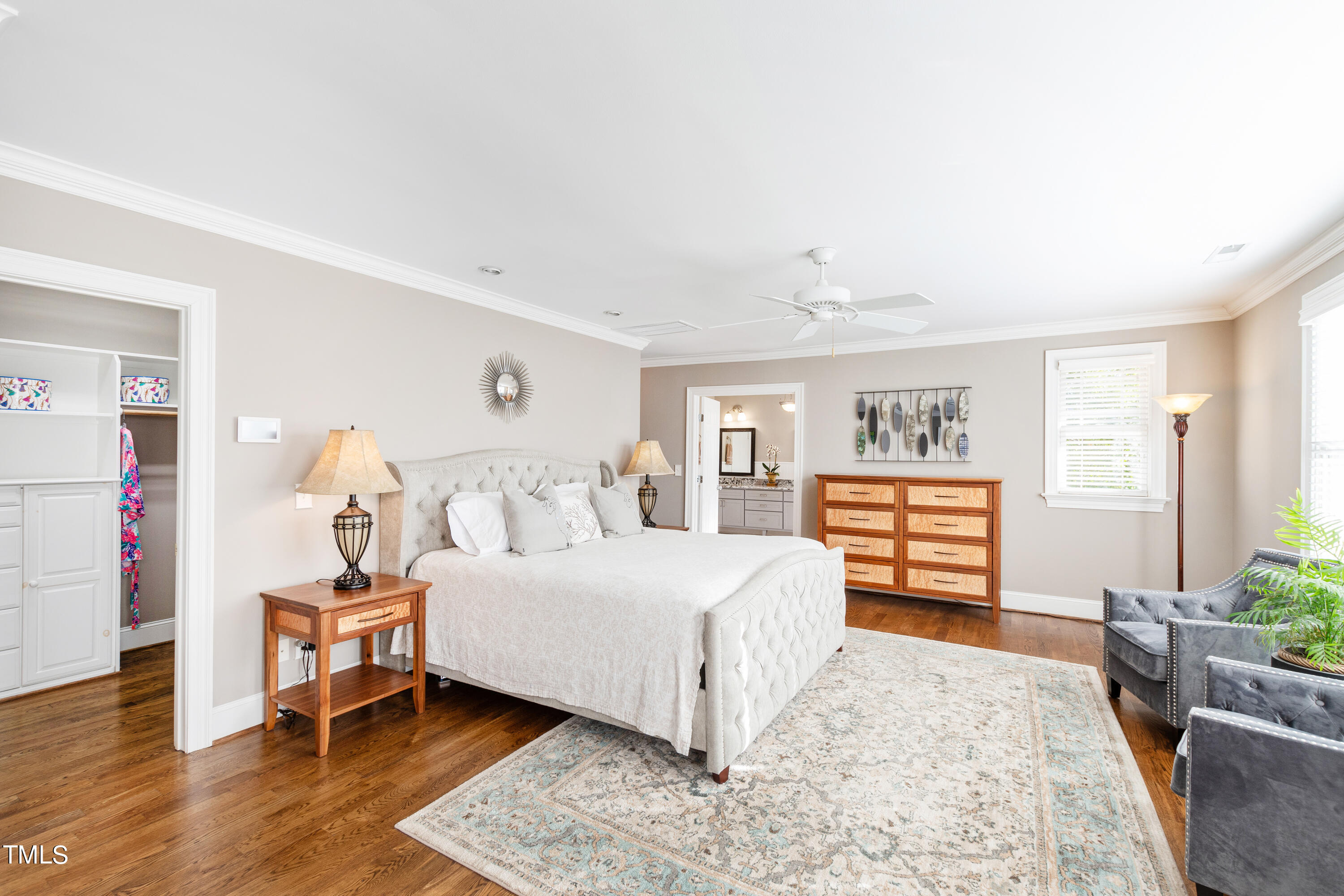 229 Woodburn Road Raleigh, NC 27605 - Photo 23 of 64 a bedroom with a large bed and a chandelier