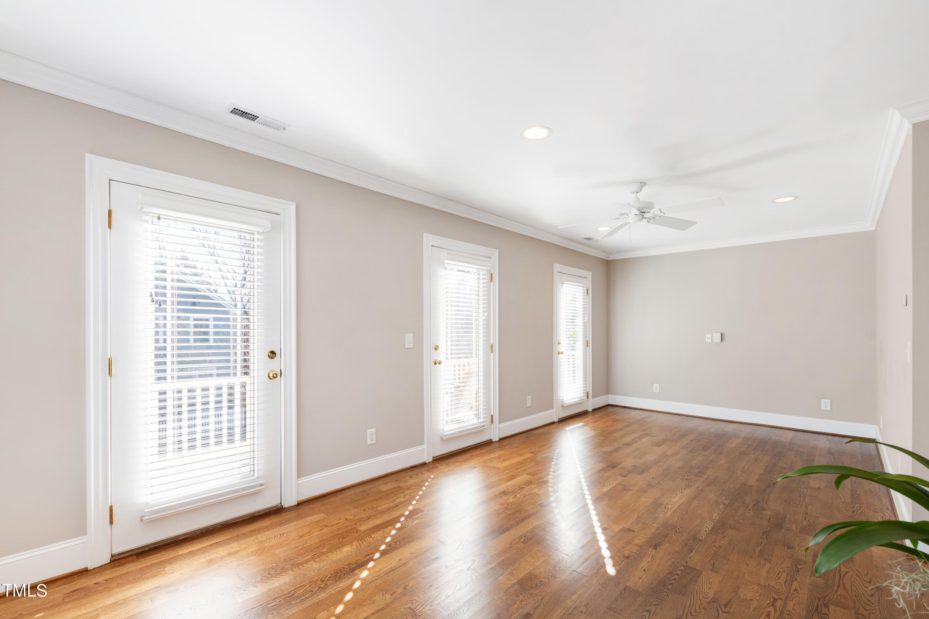 229 Woodburn Road Raleigh, NC 27605 - Photo 34 of 64 a view of an empty room with wooden floor and a window