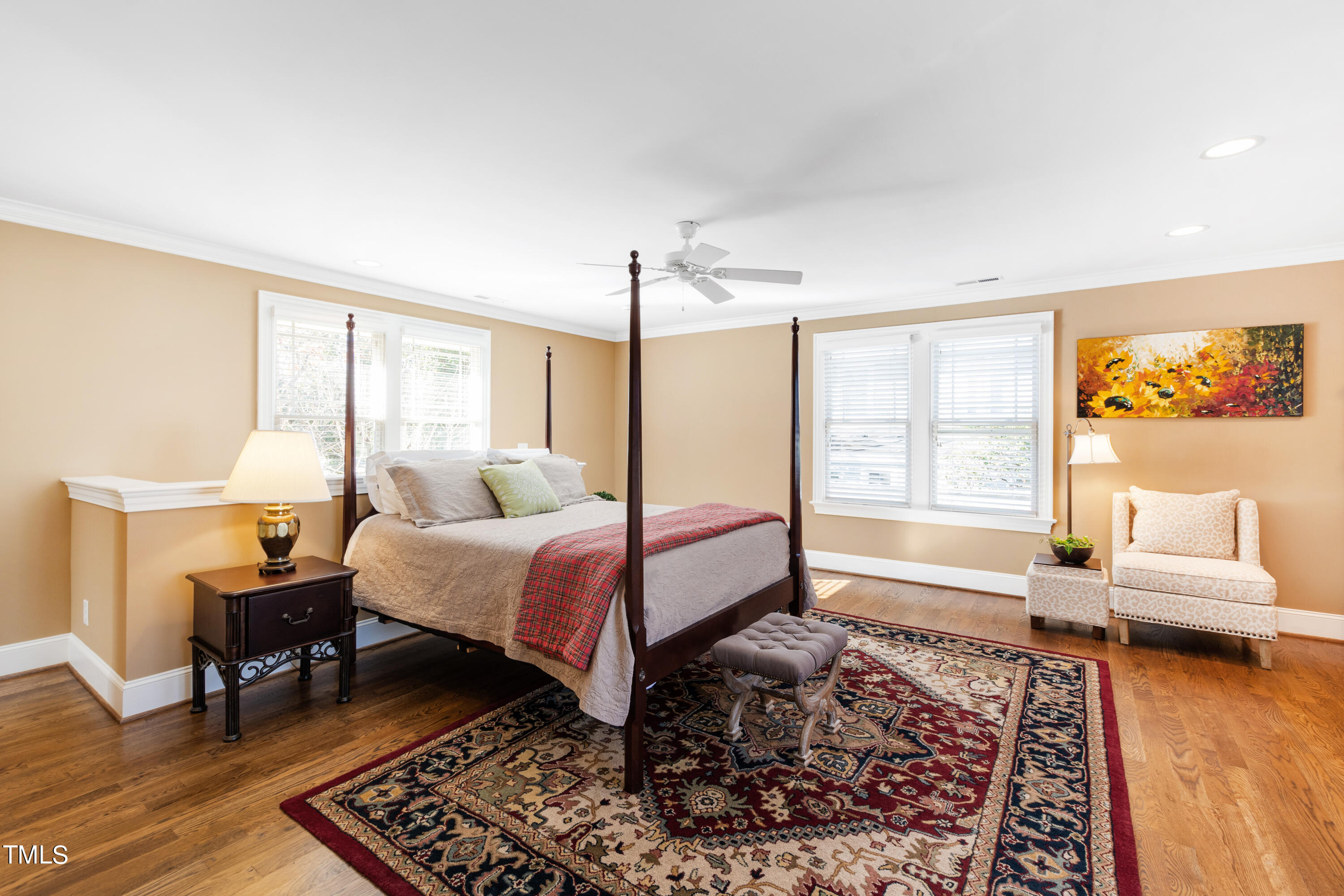 229 Woodburn Road Raleigh, NC 27605 - Photo 35 of 64 a spacious bedroom with a bed a couch and a window