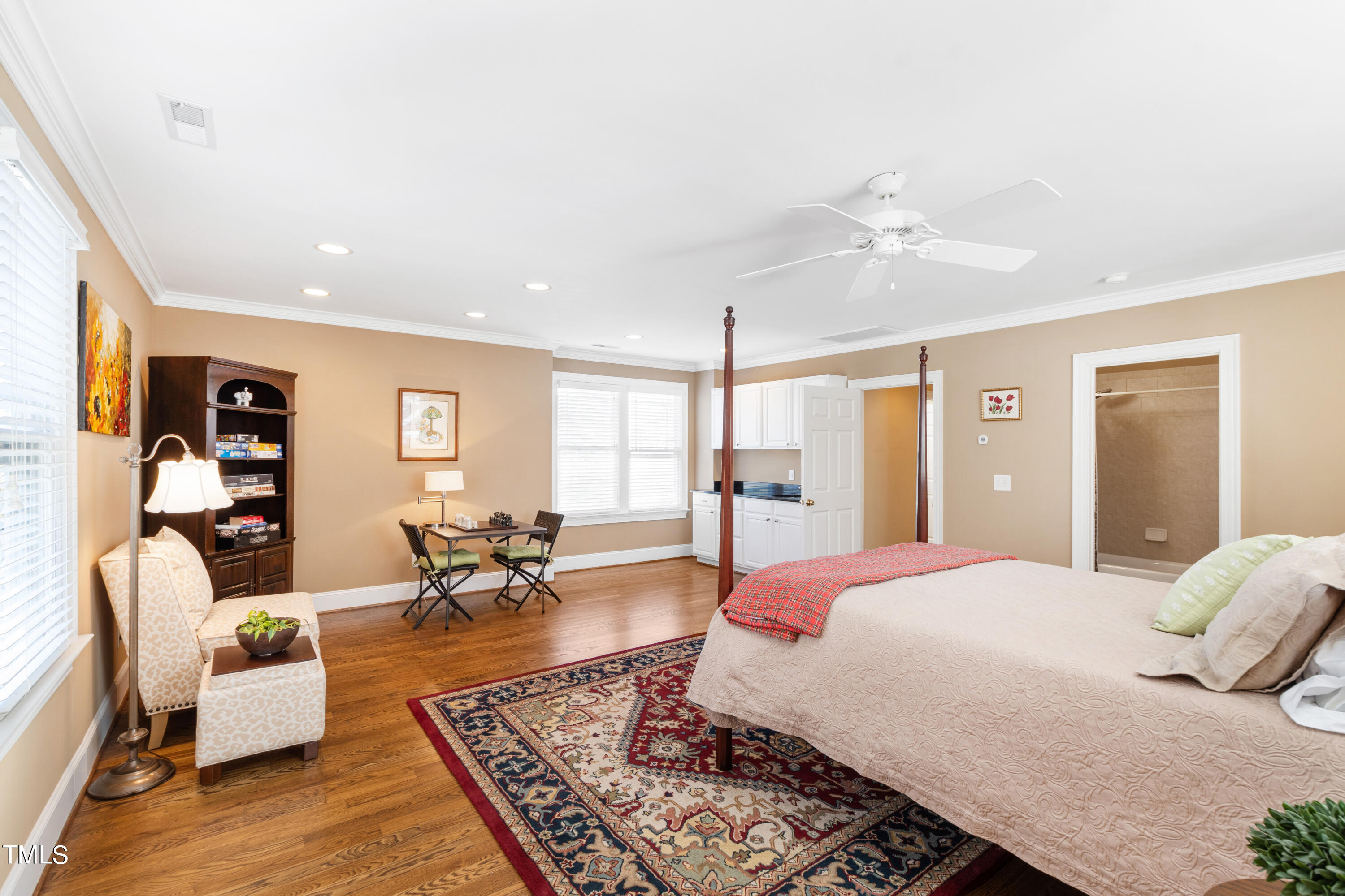 229 Woodburn Road Raleigh, NC 27605 - Photo 36 of 64 a spacious bedroom with a bed a couch and dresser