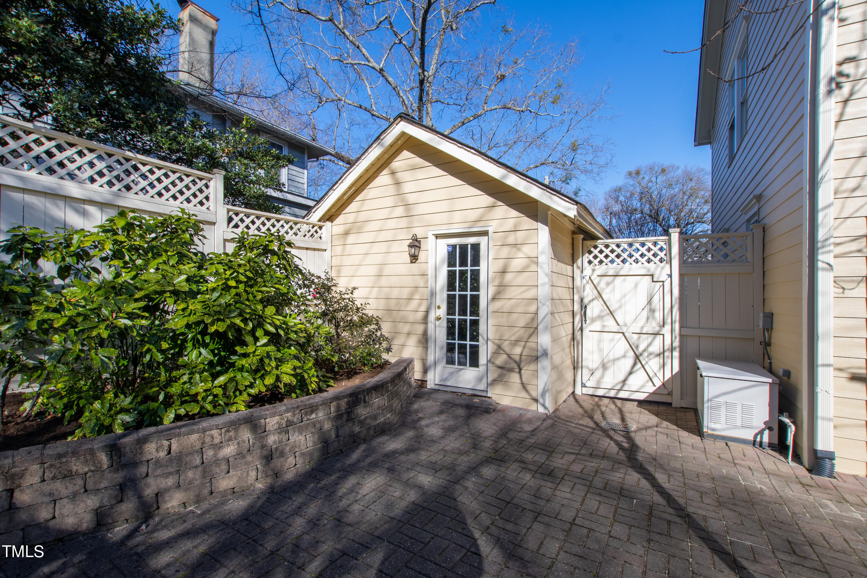 229 Woodburn Road Raleigh, NC 27605 - Photo 47 of 64 a view of backyard with large tree and wooden fence