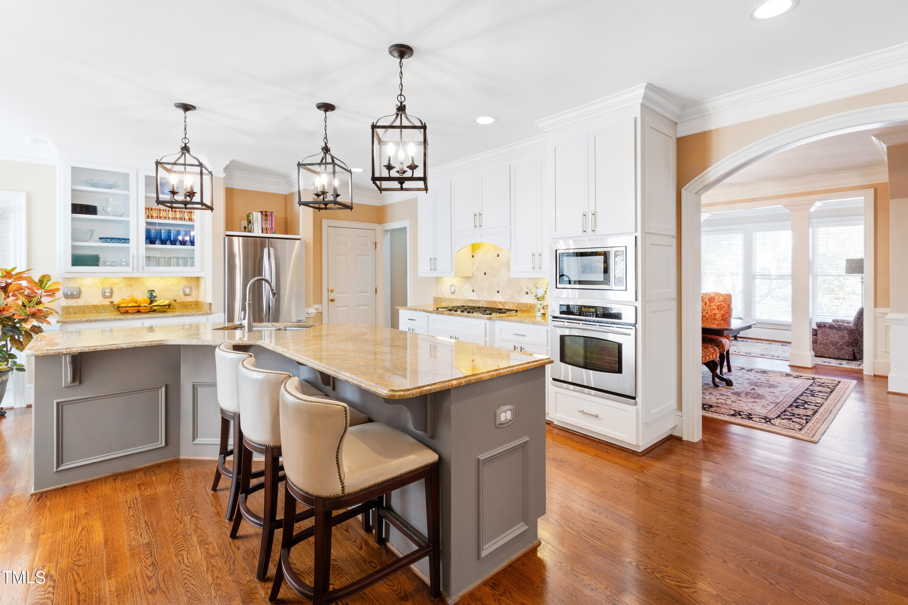 229 Woodburn Road Raleigh, NC 27605 - Photo 7 of 64 a kitchen with stainless steel appliances kitchen island granite countertop a table chairs and a refrigerator