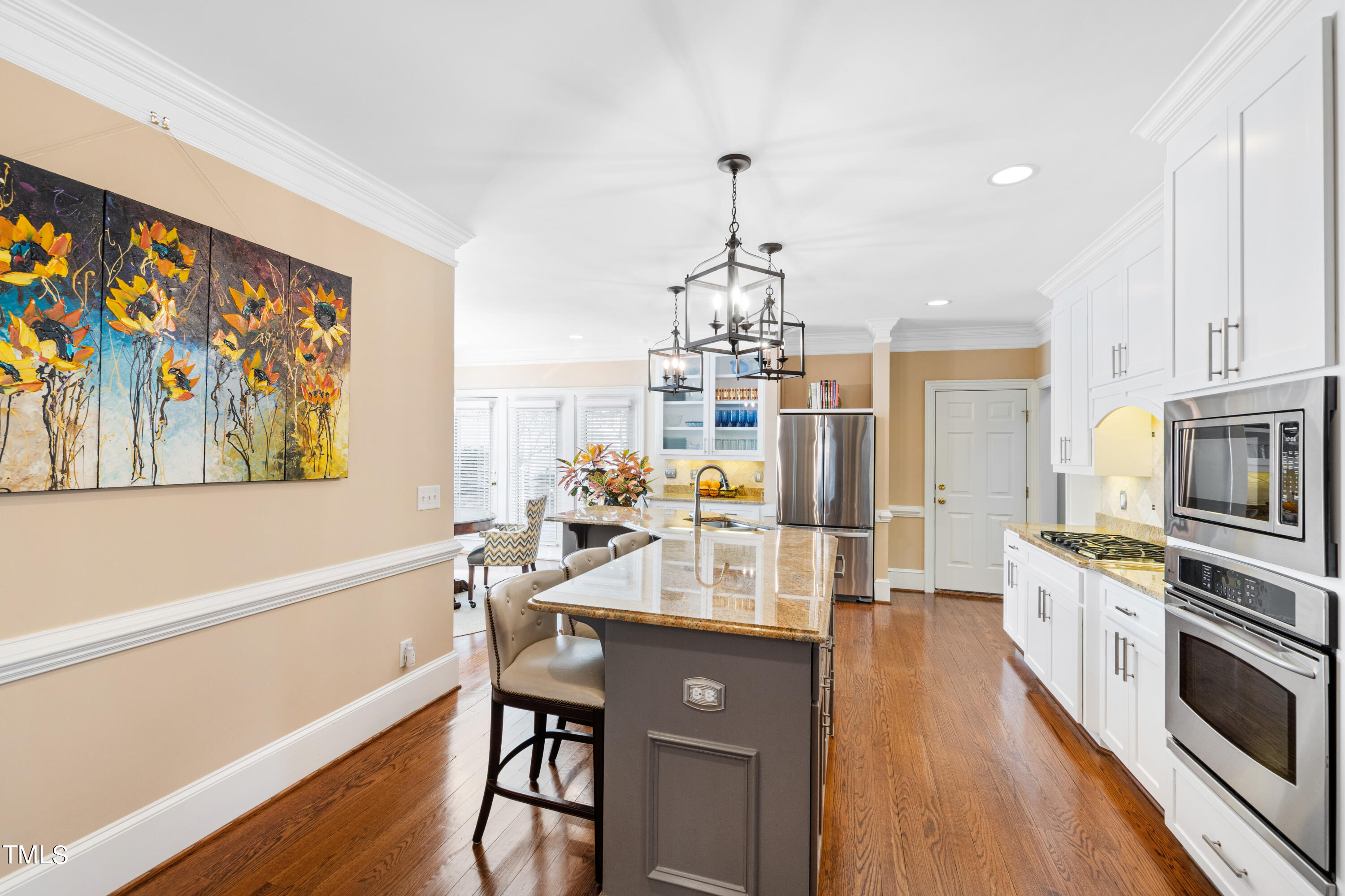 229 Woodburn Road Raleigh, NC 27605 - Photo 10 of 64 a large kitchen with a table chairs stainless steel appliances and cabinets