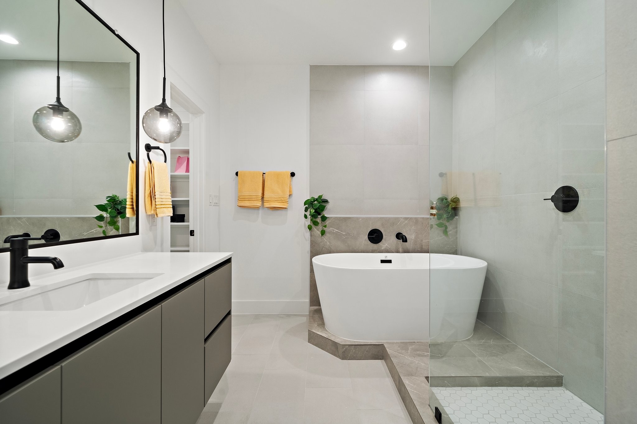 Experience ultimate relaxation in this stunning luxury spa-inspired bathroom, featuring a spacious central freestanding bathtub as its centerpiece.