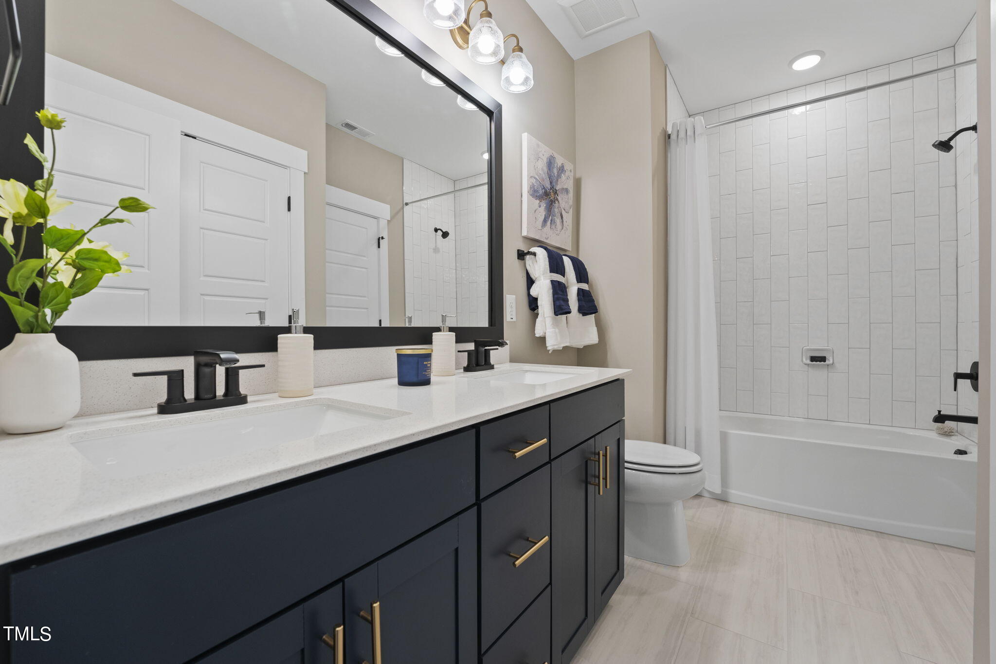 2130 Mars Hill Lane Apex, NC 27502 - Photo 15 of 21 a bathroom with a sink a toilet a tub and a mirror