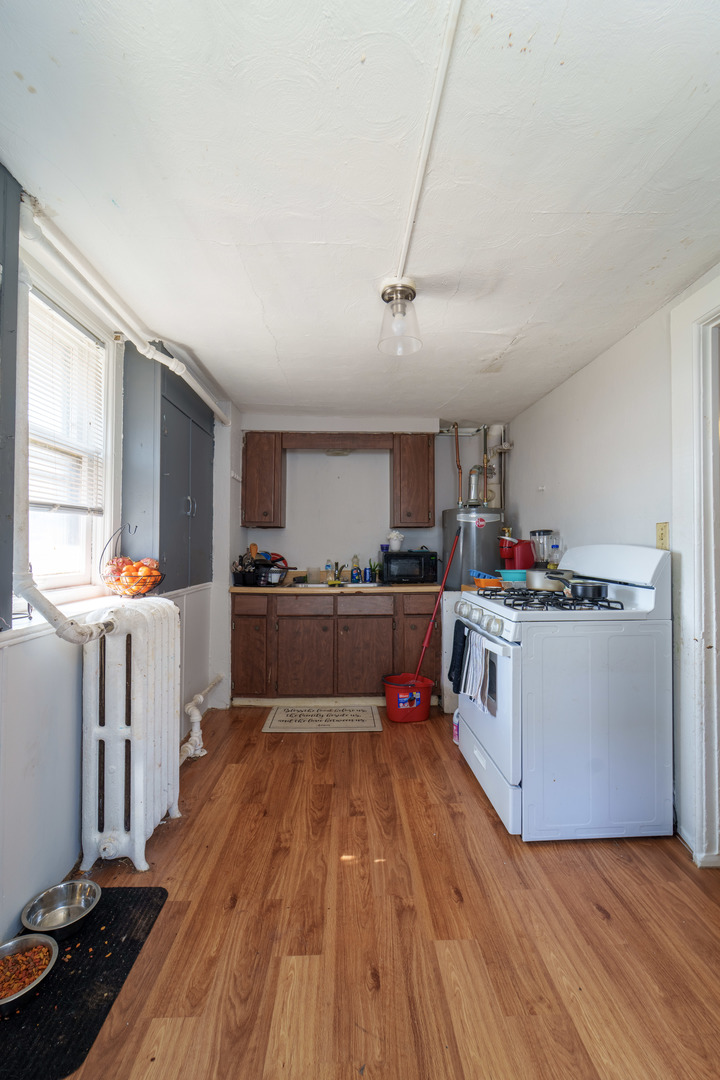167 Cherry Street Elgin, IL 60120 - Photo 15 of 24 a kitchen with wooden floors and white appliances