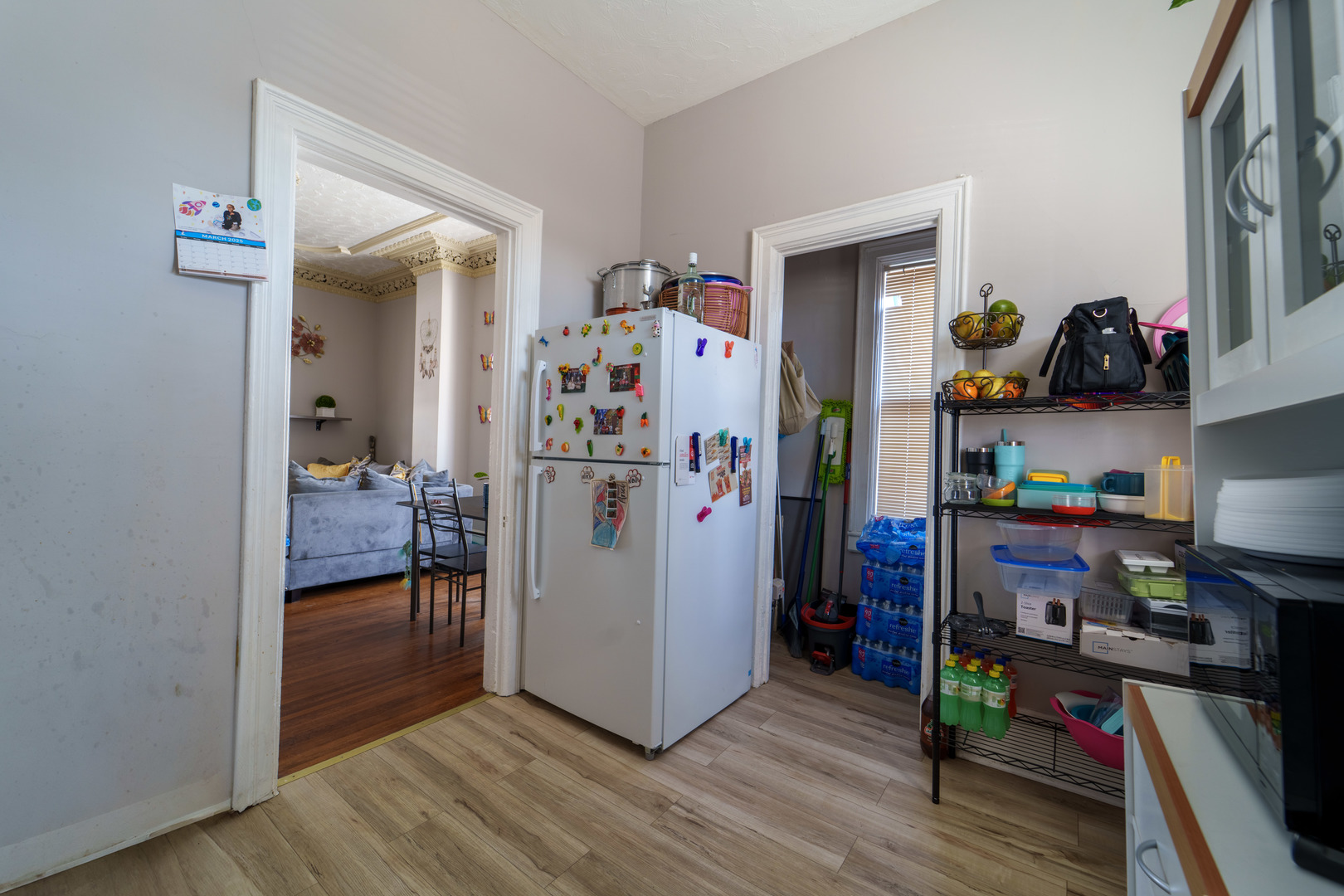 167 Cherry Street Elgin, IL 60120 - Photo 5 of 24 a view of a hallway to room with wooden floor and closet