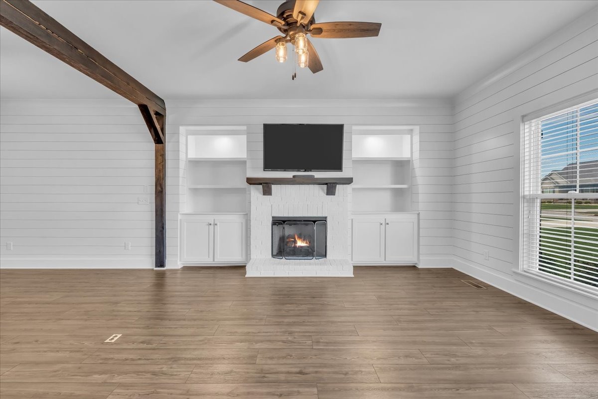 188 Bluegrass Drive Manchester, TN 37355 - Photo 11 of 84 a view of a livingroom with a fireplace a ceiling fan and windows