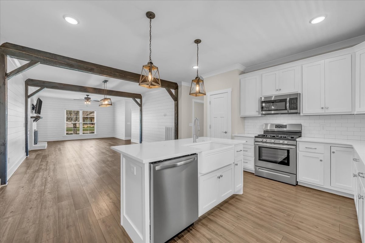188 Bluegrass Drive Manchester, TN 37355 - Photo 26 of 84 a kitchen with stainless steel appliances granite countertop a stove and white cabinets