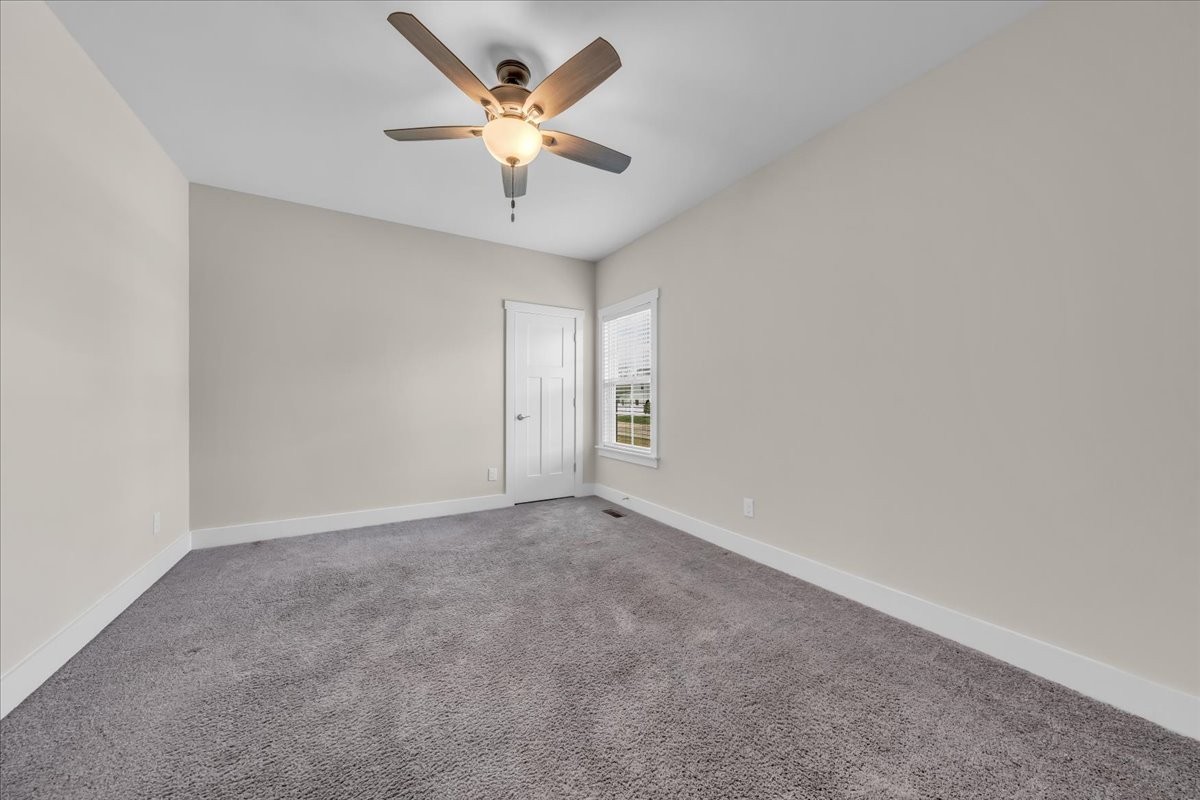 188 Bluegrass Drive Manchester, TN 37355 - Photo 40 of 84 an empty room with a ceiling fan and a window