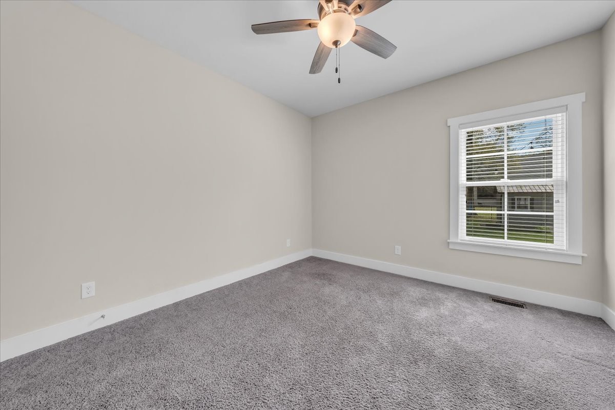 188 Bluegrass Drive Manchester, TN 37355 - Photo 45 of 84 an empty room with a chandelier fan and windows
