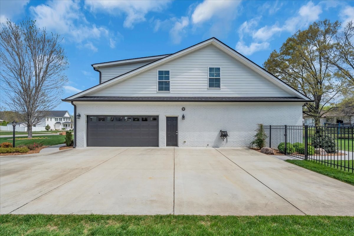 188 Bluegrass Drive Manchester, TN 37355 - Photo 8 of 84 a front view of a house with a yard and garage