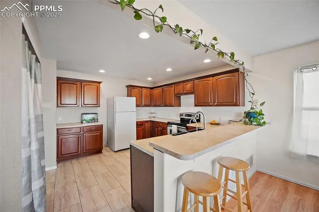 a kitchen with furniture a center island and stainless steel appliances