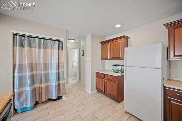 a kitchen with stainless steel appliances granite countertop a refrigerator and a sink