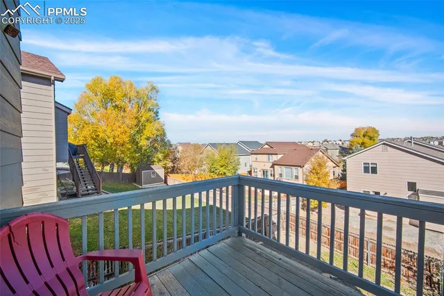 a view of a balcony with wooden floor and fence