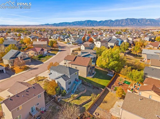 an aerial view of residential houses with outdoor space
