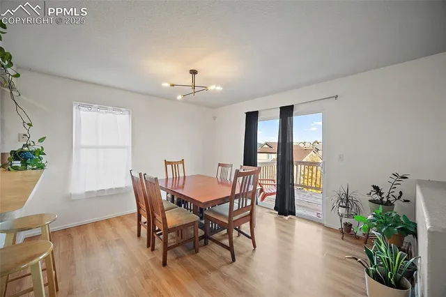 a view of a dining room with furniture window and wooden floor