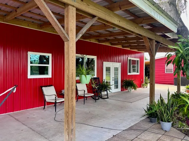 a view of a porch with a table and chairs