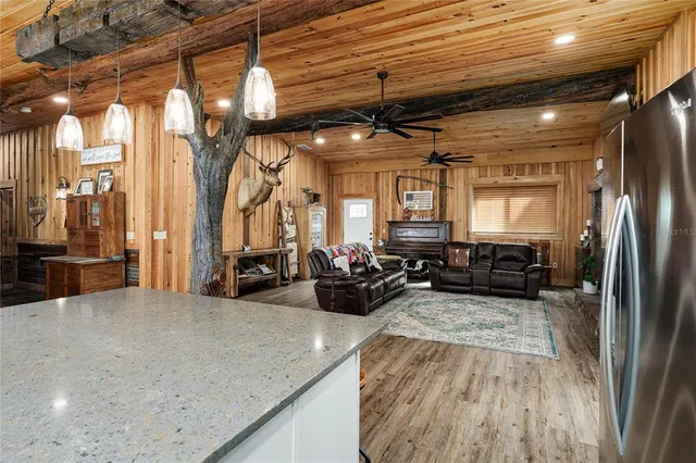 a bedroom with a bed dresser and a flat tv screen