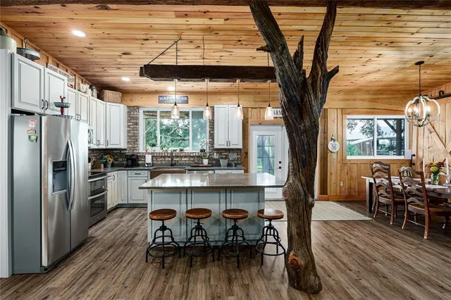 a bedroom with a bed a flat screen tv and dresser
