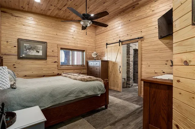 a bathroom with a granite countertop toilet sink and mirror