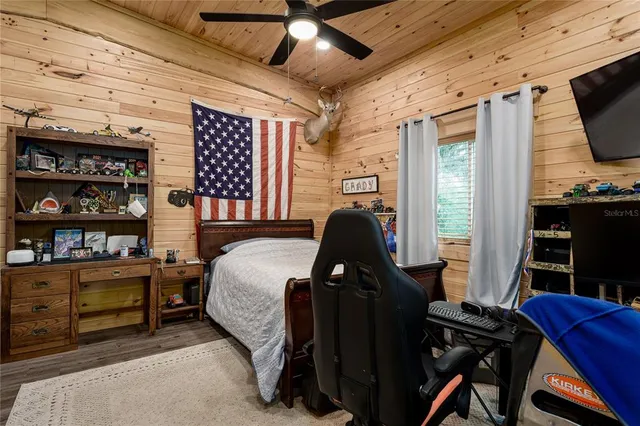 a backyard of a house with plants and a tree
