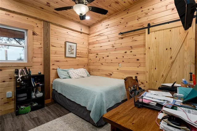 a front view of a house with a garden and trees