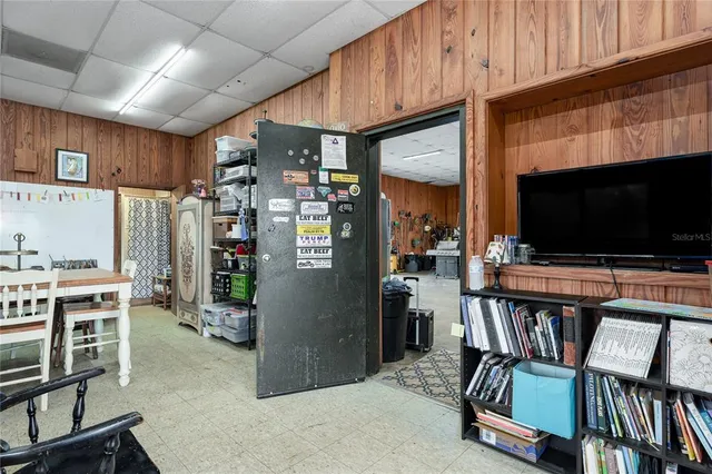a view of a big house with a big yard and large trees