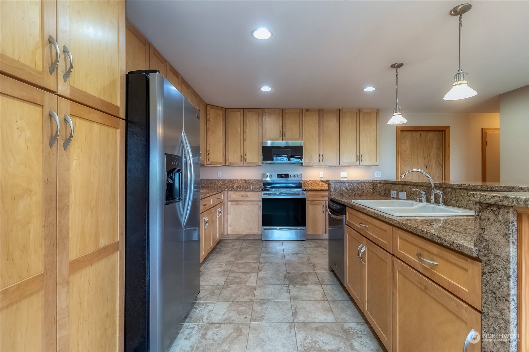 266 Thurber Road Touchet, WA 99360 - Photo 14 of 39 a kitchen with kitchen island a sink stainless steel appliances and cabinets