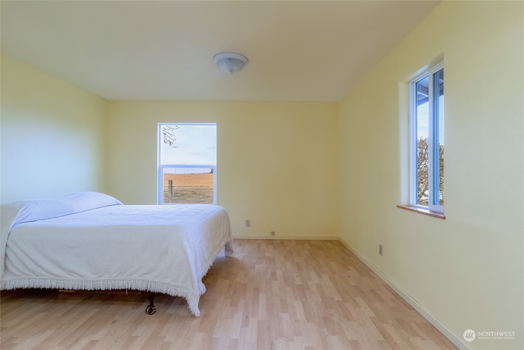 266 Thurber Road Touchet, WA 99360 - Photo 18 of 39 a bedroom with a bed and wooden floor