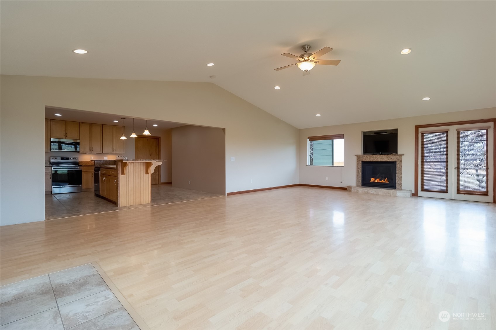 266 Thurber Road Touchet, WA 99360 - Photo 5 of 39 a view of a livingroom with a kitchen space a sink a refrigerator and windows