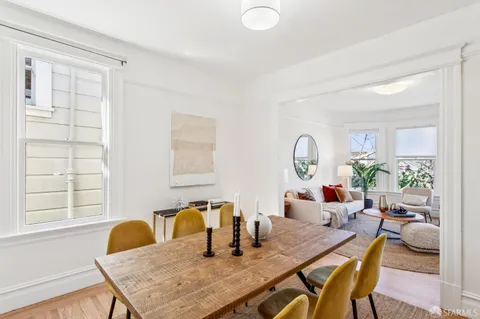 a dining room with furniture and window