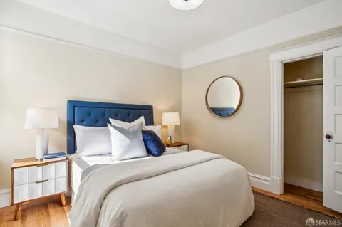 a bedroom with a bed and a lamp