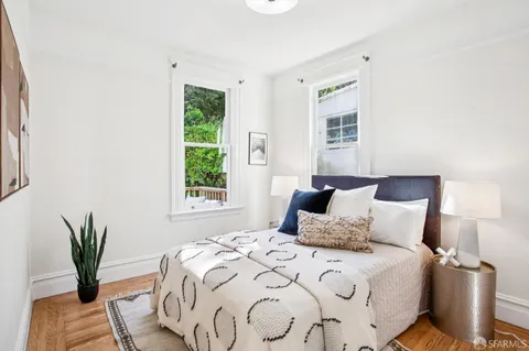 a bedroom with a large bed and a window