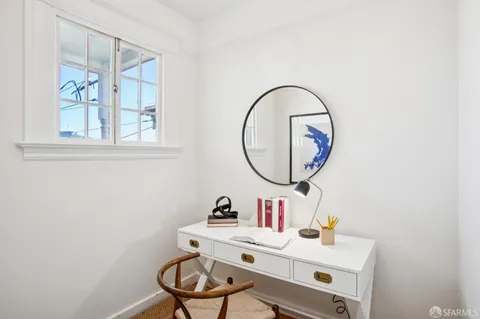 a bathroom with a sink mirror and a window
