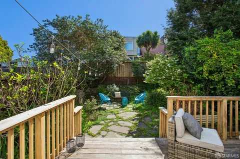 a view of a chair and table in backyard