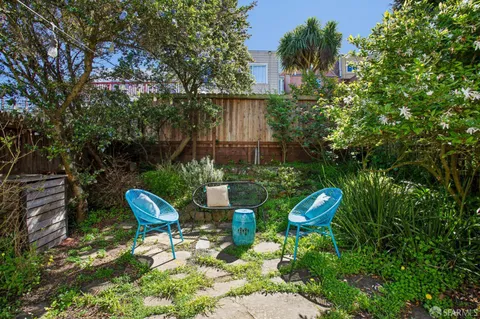 a view of house with backyard outdoor seating and green space