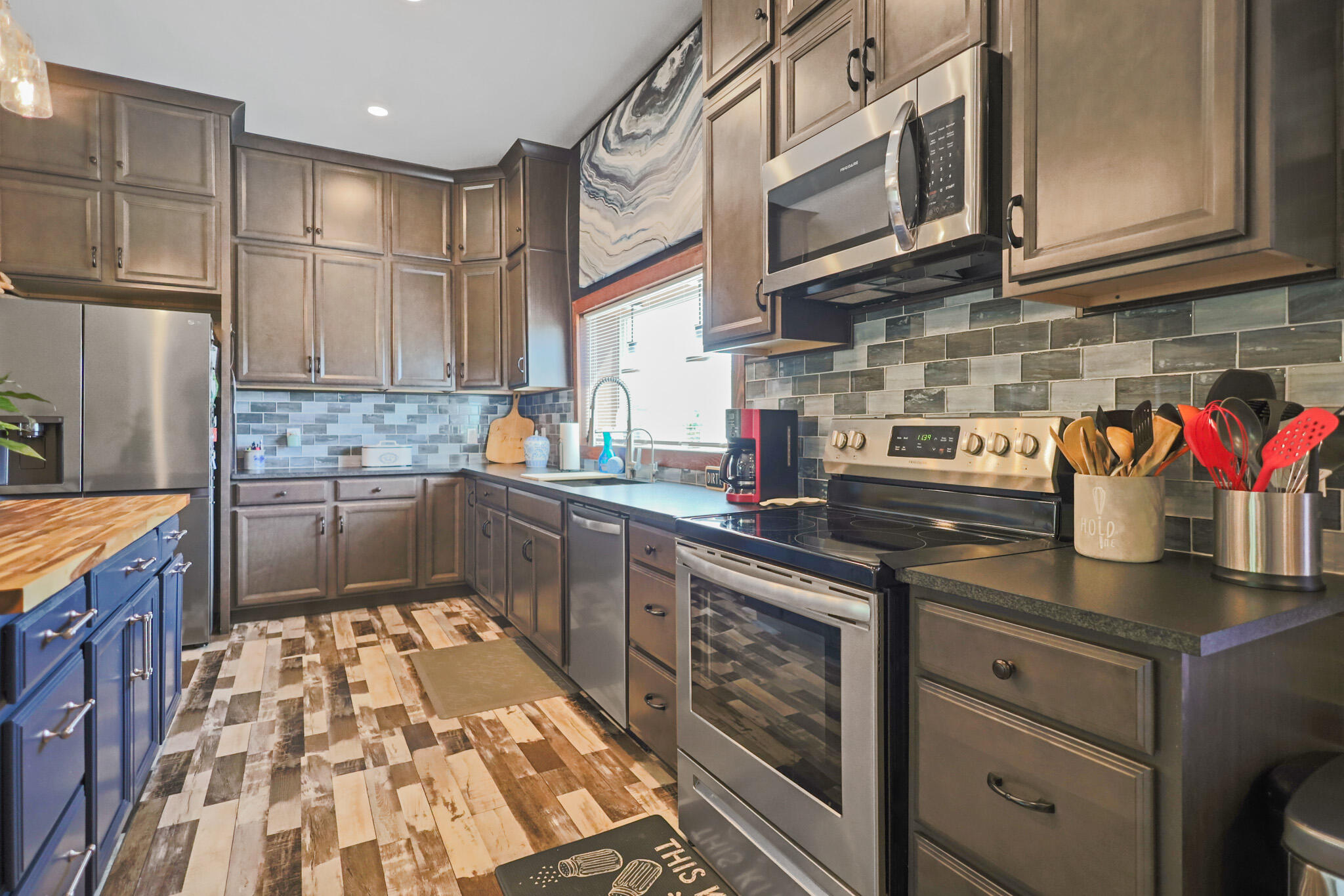 301 Fagan Road Snyder, TX 79549 - Photo 41 of 102 a kitchen with stainless steel appliances granite countertop a sink a stove and cabinets