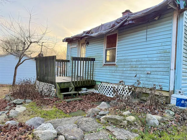 a brick house with a small yard and wooden fence