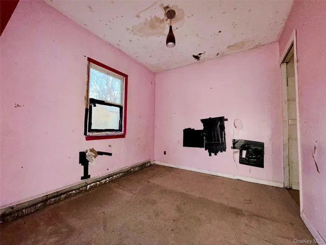 a room with chandelier and wooden floor