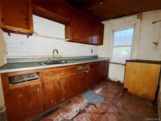 a kitchen with stainless steel appliances granite countertop a sink a stove and a refrigerator
