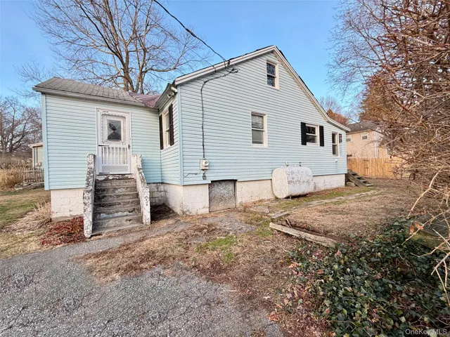 a view of a white house with a yard covered in snow