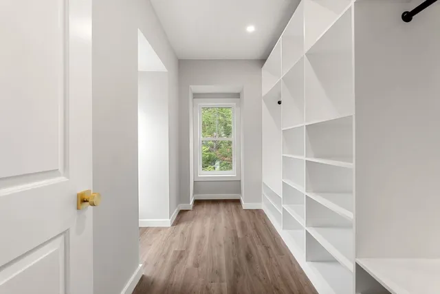 a view of a hallway view with wooden floor and staircase