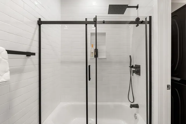 a bathroom with a glass shower door