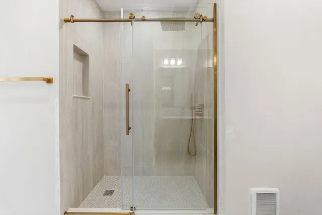 a bathroom with a shower and a bath tub