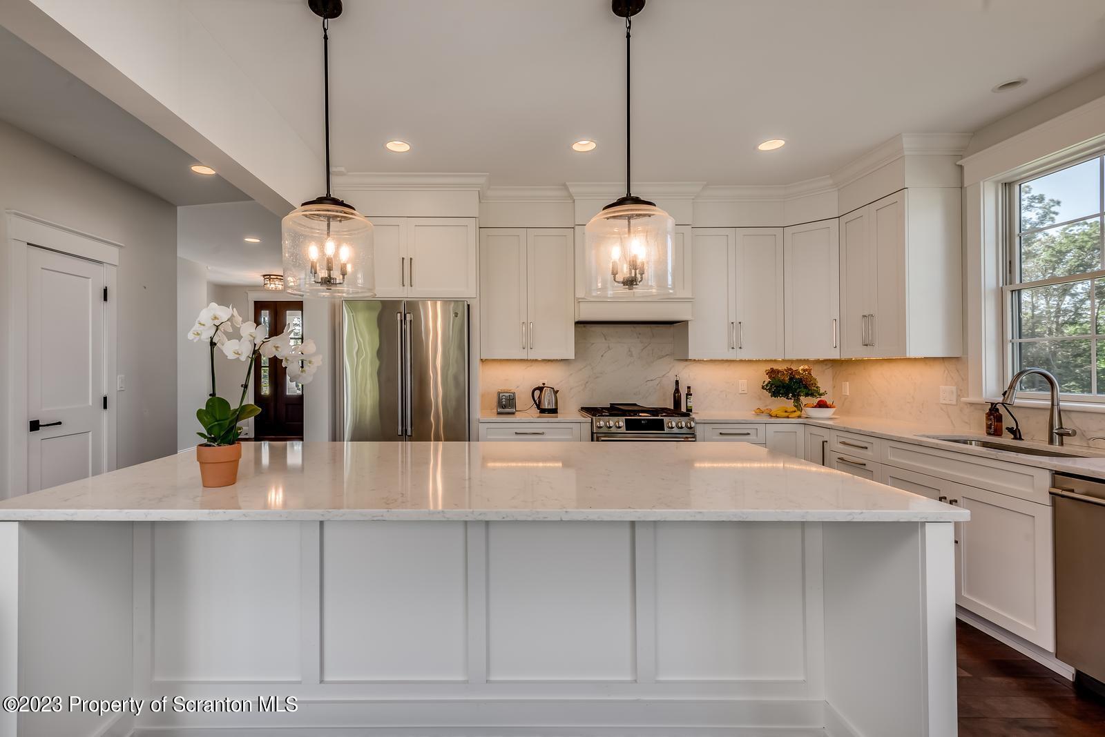 115 Rock Ridge Drive Clarks Summit, PA 18411 - Photo 16 of 43 a large kitchen with kitchen island white cabinets and stainless steel appliances